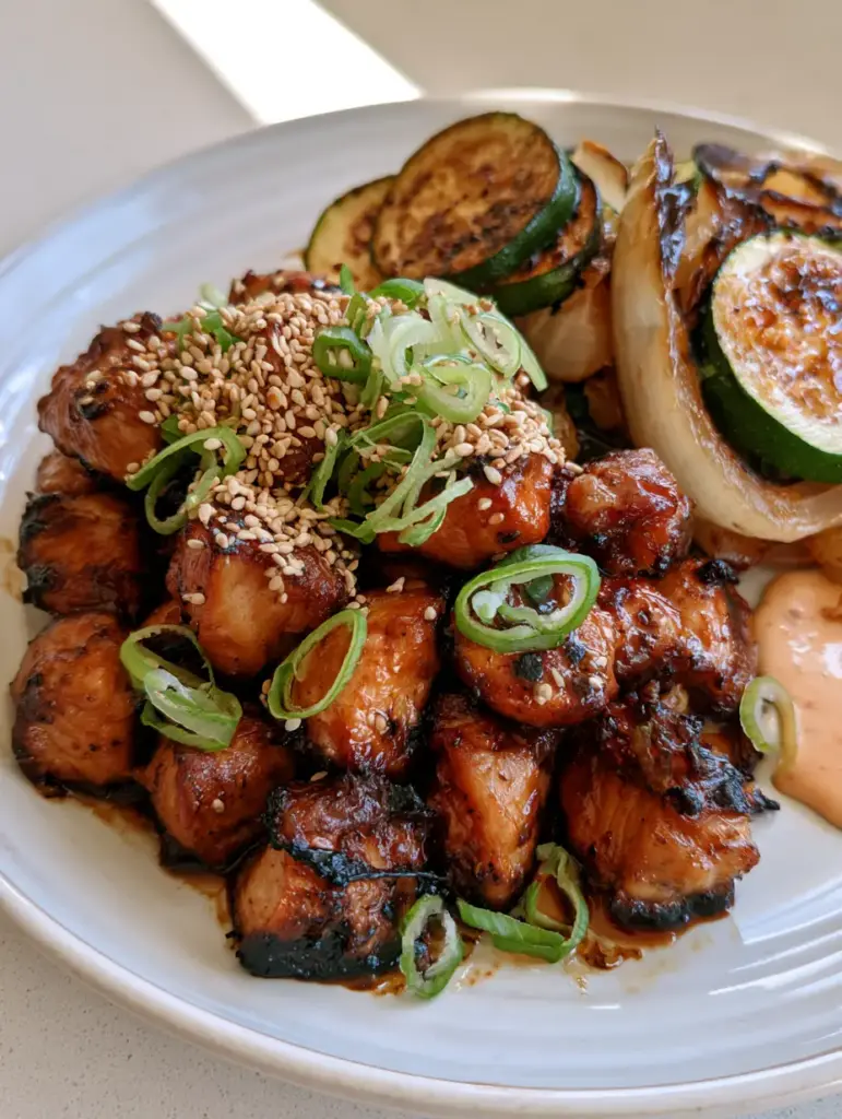 Hibachi Chicken Recipe: Better Than The Japanese Steakhouse! 1 Sautéed zucchini half-moons and caramelized onion wedges with blistered edges on a white plate. (Hibachi Chicken Recipe)